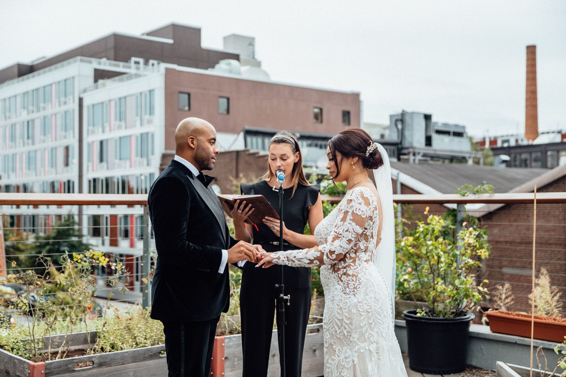 Groom putting the ring on bride