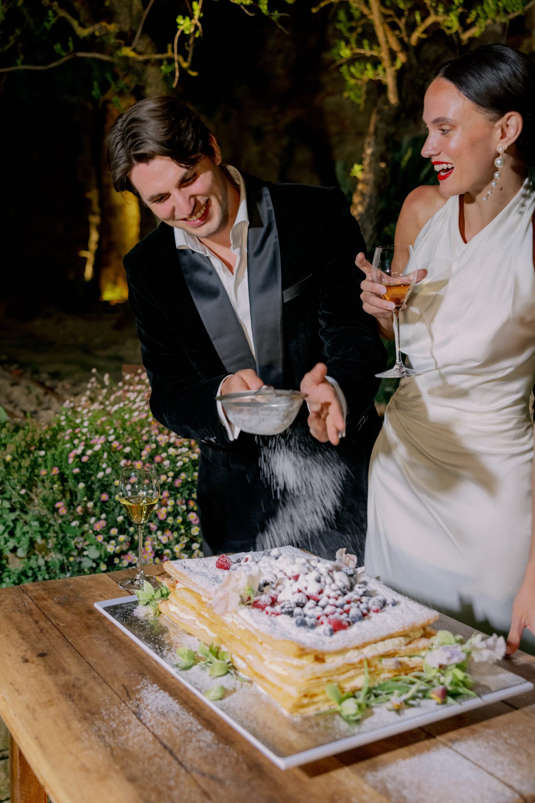 Bride and groom cutting cake in Italy